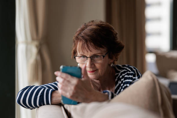istock Woman at home reading her phone 1364916224
