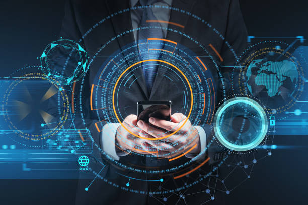 istock Businessman wearing formal suit is holding smartphone with digital interface 1364916288