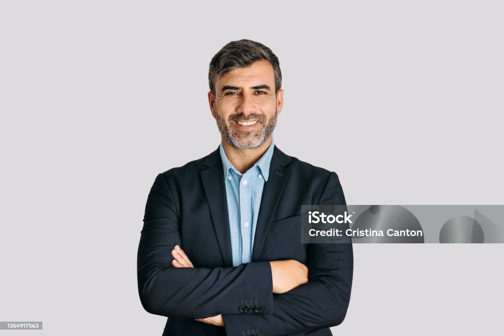 Businessman smiling with arms crossed on white background Front view of businessman smiling with arms crossed on white background Men Stock Photo