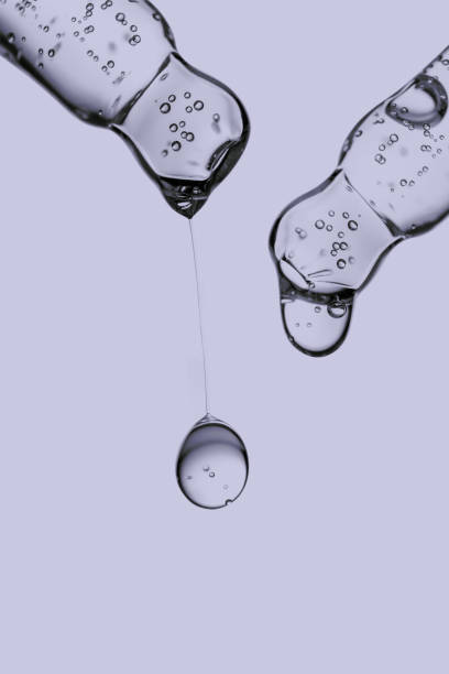 istock Transparent pipettes with cosmetics on a very peri background. 1364917600