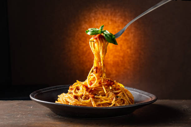 istock Spaghetti pasta bolognese in black plate. 1364918817
