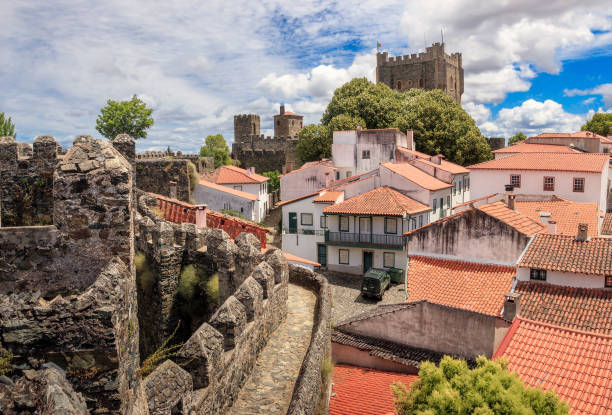 Exterior walls and houses of the citadel of Bragança in Portugal, with the castle keep in the background. stock photo