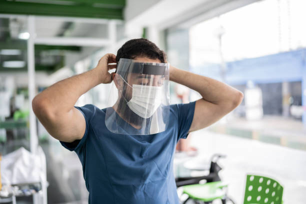 Nurse putting on face shield at vaccination center