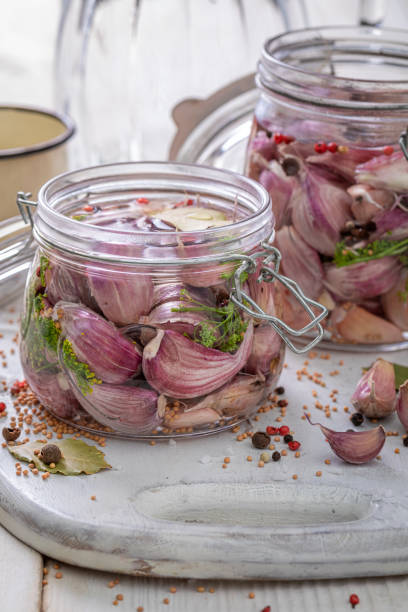 istock Preparation for pickled garlic with allspice, bay leaf and salt. 1364926218