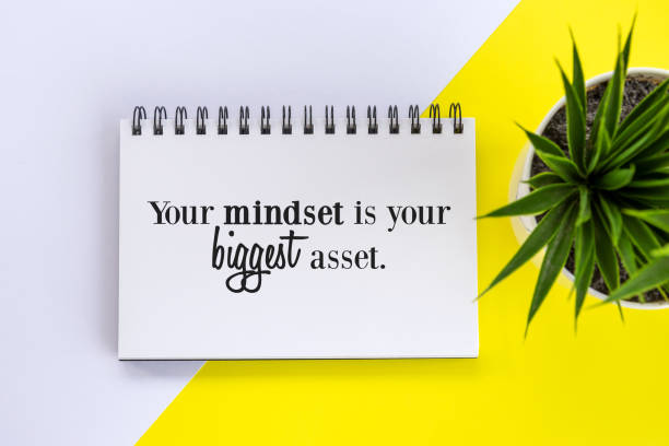 istock Your mindset is your biggest asset. Positive handwritten motivational message on a notebook with green plant in pot on the table. 1364927757