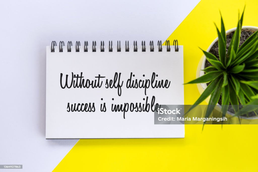 Self Discipline text concept on spiral book with plant on white and yellow table background. Positive motivational note on a book - Without self discipline success is impossible. Business flat lay with plant in a small pot on the white and yellow table background. Be discipline concept. Motivation Stock Photo