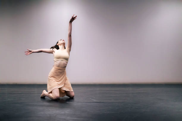 istock Young girl performing contemporary dance on stage 1364928569