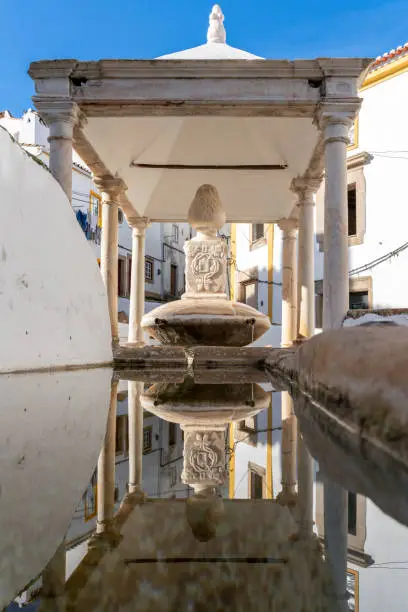 Photo of view in symmetry of Fonte da Vila, a medieval fountain in the city of Castelo de Vide in Portugal.