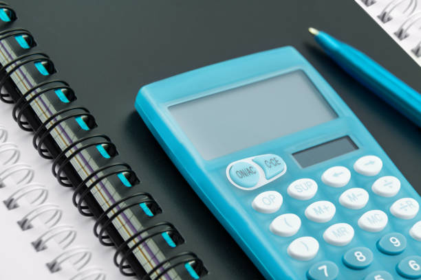 istock Finances with blue calculator and notice books 1364929705