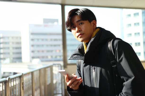 istock Young man is waiting for public transportation to arrive 1364929860
