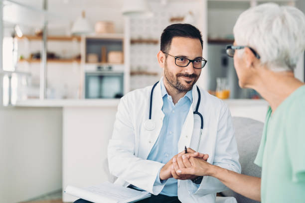 istock Doctor holding senior patient's hand 1364929987