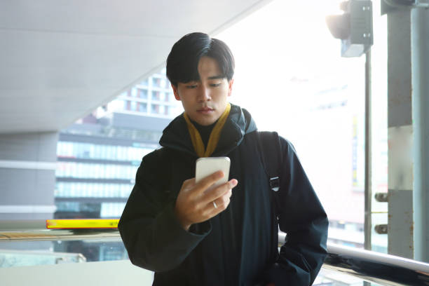 istock Young man is waiting for public transportation to arrive 1364930158