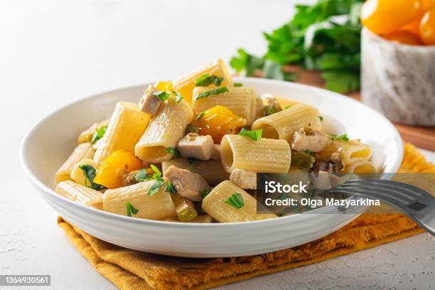 Paccheri Pasta With Swordfish Cherry Yellow Tomato And Zucchini Close Up Stock Photo - Download Image Now