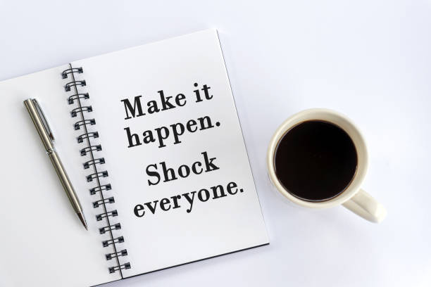 istock Positive motivational words on a notebook - Make it happen. Shock everyone. 1364931703