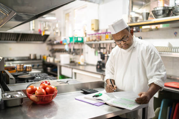 istock A chef is balancing the accounts in the kitchen 1364935486