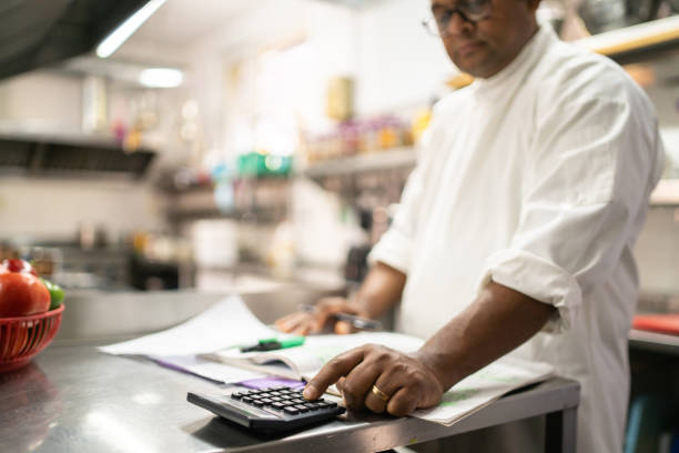 istock An Indian chef calculating his kitchen accounts 1364935495
