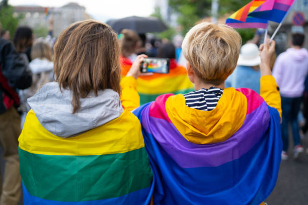 istock LGBT women wearing flags during pride event 1364936673