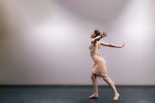 istock Young girl performing contemporary dance on stage 1364936822