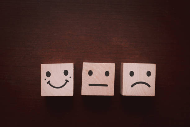 istock Close up smiley face icon on wood cube, customer Service rating, evaluation and satisfaction survey concept 1364943250