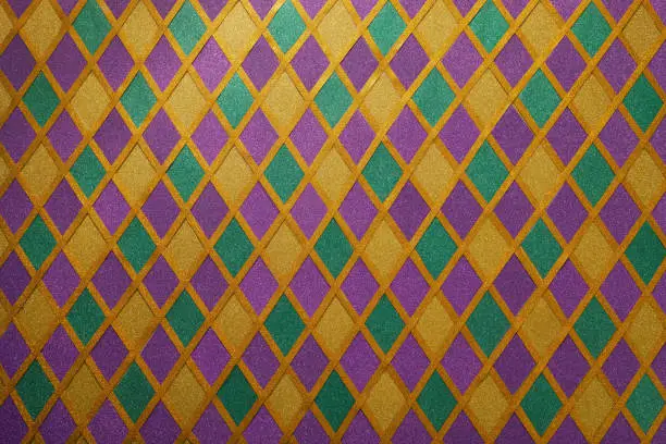 Shiny green, purple and golden glittering paillettes diamonds fabric. Mardi Gras holiday background