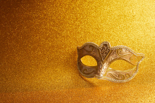 Carnival mask on a glitter golden background.