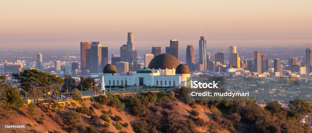Los Angeles city skyline and Griffith Observatory at sunset Los Angeles city skyline and Griffith Observatory at sunset, California City Of Los Angeles Stock Photo