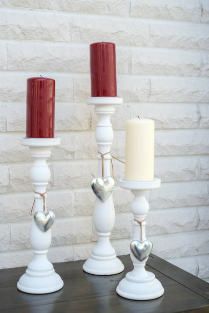 istock 3 white candlesticks with large stand on a dresser 1364946261