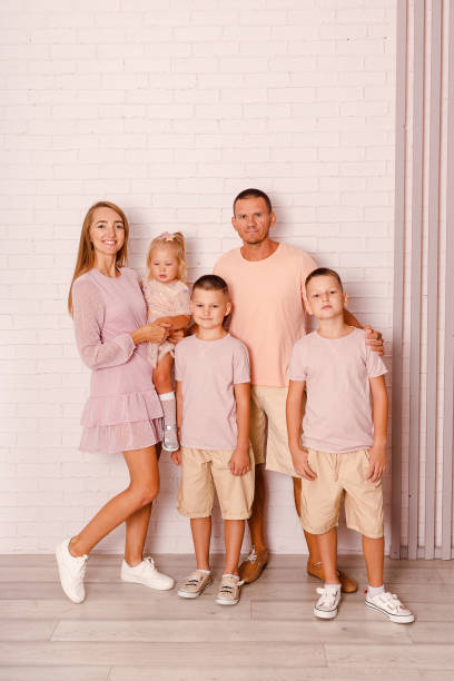 istock parents and three children stand at full height 1364949209