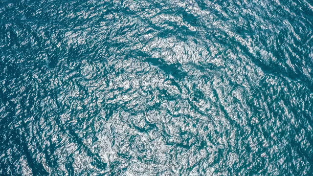 Aerial footage of blue ocean and sparkling water