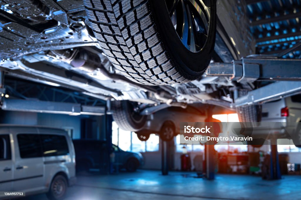 Auto service interior background with cars on the lift. Auto Repair Shop Stock Photo