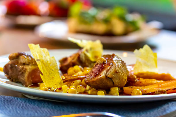 istock Stewed duck breast with vegetables and corn is on a plate. 1364957003