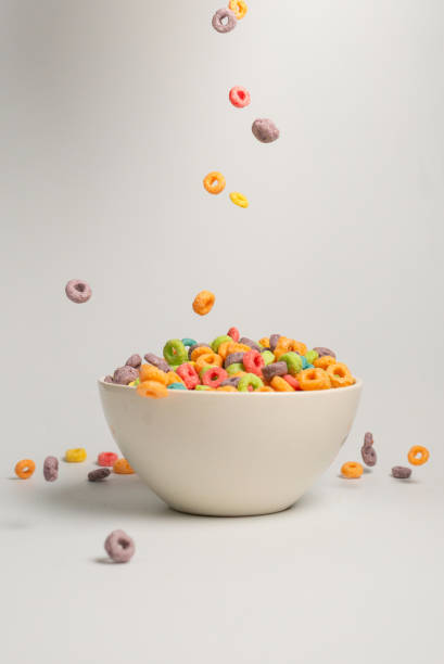 istock Colorful cereal box for morning breakfast. Corn flakes falling to the white bowl. Motion. 1364957363