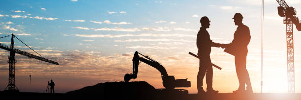 istock Architects Shaking Hands Outdoors 1364959124
