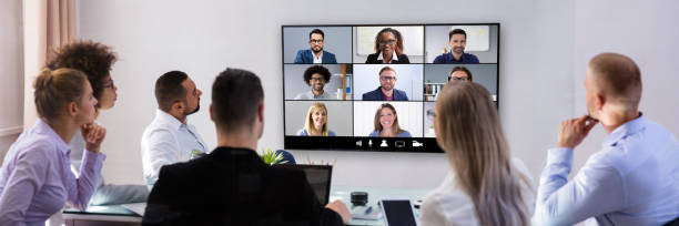 istock Businesspeople Video Conferencing In Boardroom 1364959132