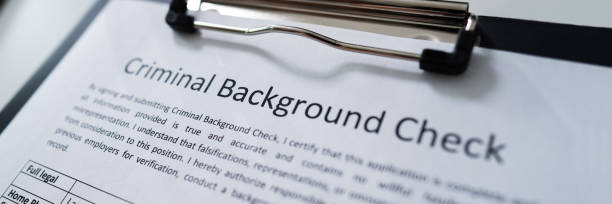istock Hand Filling Criminal Background Check Application Form 1364959468