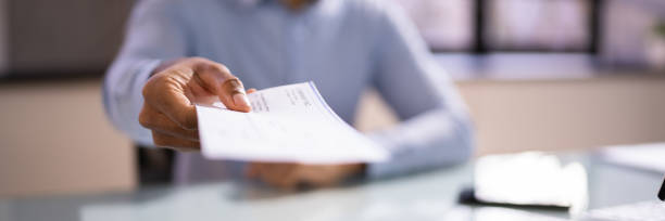 istock African Business Man Giving Paycheck 1364960347