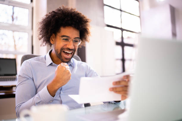 istock Happy Man Reading Good News Letter 1364960440