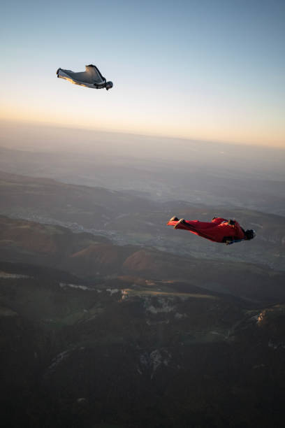 istock Wingsuit fliers soar above Swiss mountain landscape 1364962097