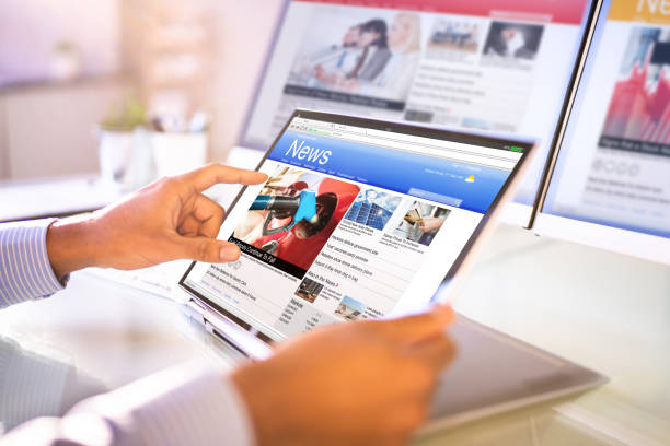 istock Watching News On Screen. Reading Newspaper Website 1364962179
