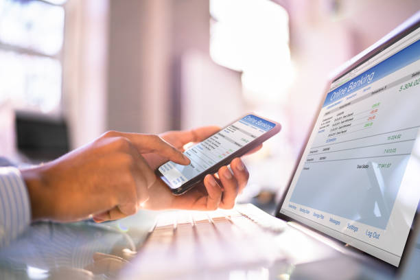 istock Online Banking On Mobile Phone And Hybrid Laptop 1364962263