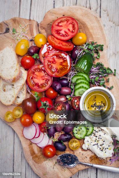 Healthy Snack Of Olives Tomatoes Olive Oil Bread And Cucumber Stock Photo - Download Image Now