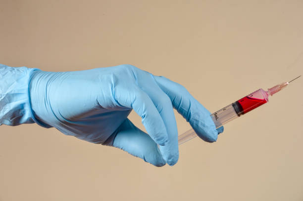 istock hand with protective gloves holding medical object 1364962658