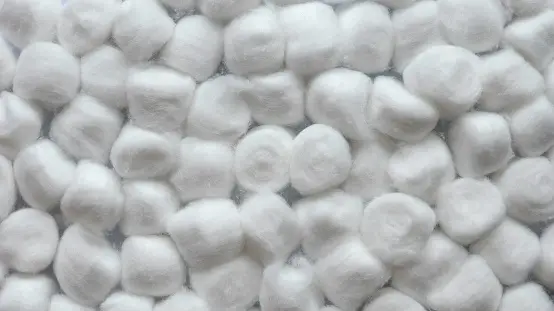 Closeup Of A Pile Of Cotton Balls Of Different Colors Stock Photo