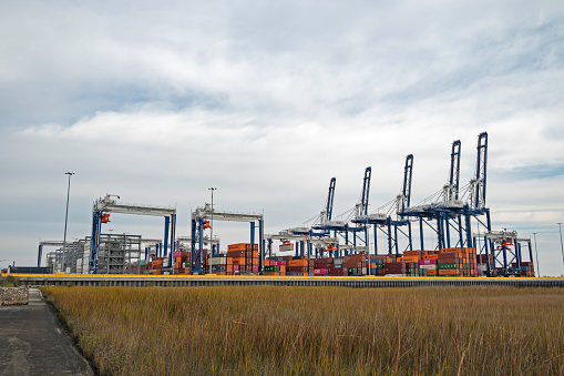 Charleston, SC, USA - January 15, 2022: Yard cranes, shipping containers, and ship-to-shore cranes at Hugh K. Leatherman Terminal, which opened in March 2021 on the Cooper River in Charleston Harbor.