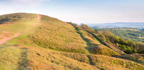 istock Walkers enjoy the Malvern Hills during a summer sunrise. 1364966069