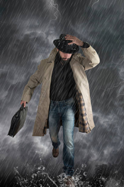 istock The man with  umbrella after an  storm, he is wet and dripping. 1364967084