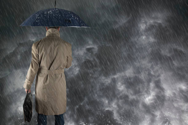 istock The man with  umbrella after an  storm, he is wet and dripping. 1364968092
