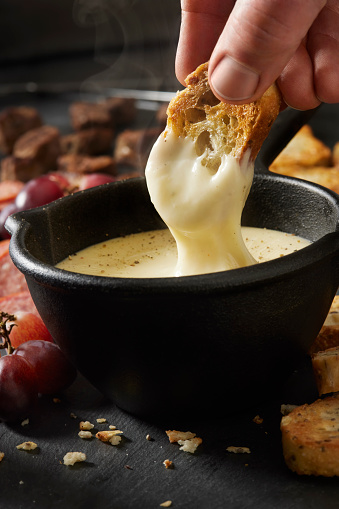 Dipping French Bread in Cheese Fondue
