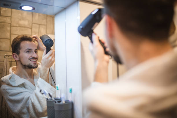 istock Handsome middle aged man drying his hair 1364968355