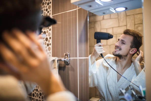 istock Handsome middle aged man drying his hair 1364968366